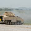 Bradley Vehicle crew firing main gun.